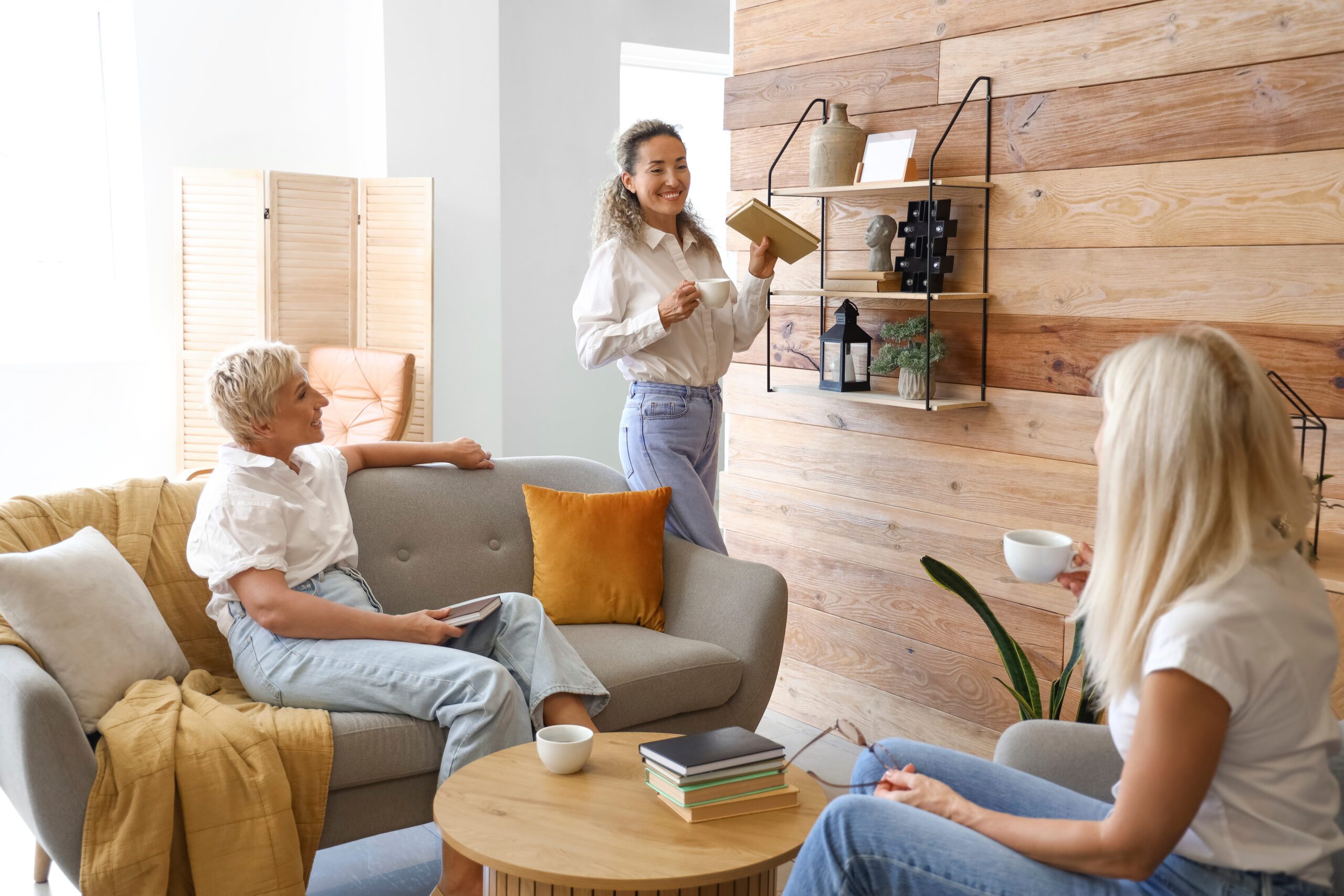 Mature women taking part in book club at home