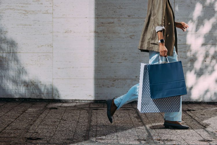 woman walking with shopping bags.