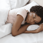 A woman laying in bed.